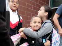 Classmates attending the Irwin Jacobs elementary school greet each other before heading into school for their first day of class as students across New Bedford return to school.  [ PETER PEREIRA/THE STANDARD-TIMES/SCMG ]